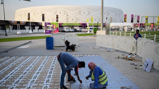 Labourers work near the Al-Thumama Stadium in Doha on November 8, 2022, ahead of the Qatar 2022 FIFA World Cup football tournament. (Photo by Kirill KUDRYAVTSEV / AFP)