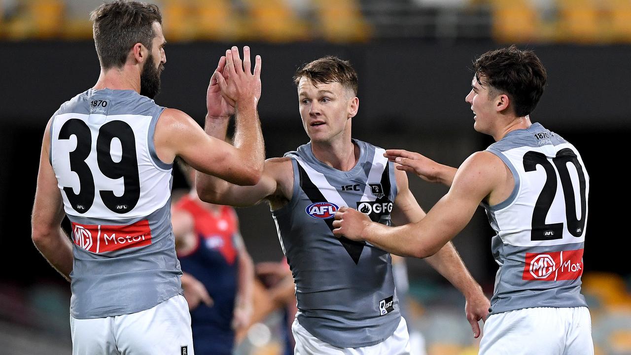 BRISBANE, AUSTRALIA - JULY 30: Connor Rozee of Port Adelaide celebrates with Robbie Gray and Justin Westhoff after kicking a goal during the round nine AFL match between the Melbourne Demons and the Port Adelaide Power at The Gabba on July 30, 2020 in Brisbane, Australia. (Photo by Bradley Kanaris/Getty Images)