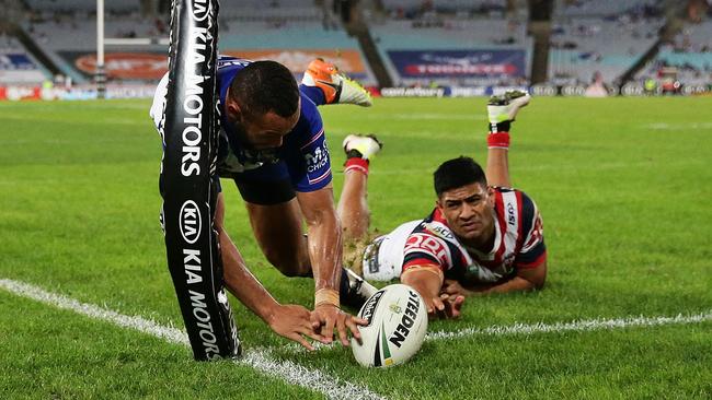 Bulldog Tyrone Phillips scores his third try during the match against the Roosters. Picture: Brett Costello