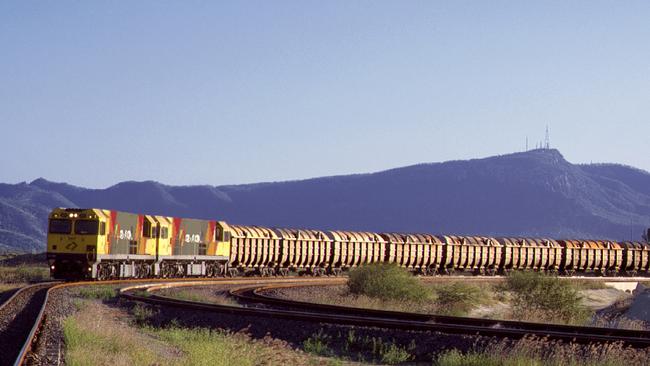 An Aurizon bulk concentrates train with Mount Stuart in the background.