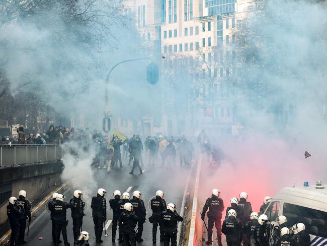 Protesters face riot police as they take part in a demonstration against Covid-19 measures, including the country's health pass, in Brussels. Picture: AFP