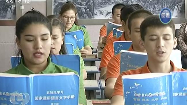 Young Muslims read from official Chinese language textbooks in classrooms at the Hotan Vocational Education and Training Center in Hotan, Xinjiang, northwest China. Picture: CCTV via AP Video