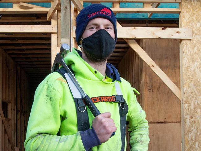 The building and construction industry scrambles to figure how to work under new stage four lockdown rules. Builders Daniel Billing (yellow), Zak Whitnell (orange) and Tyler Brindle (blue) on site. Picture: Mark Stewart