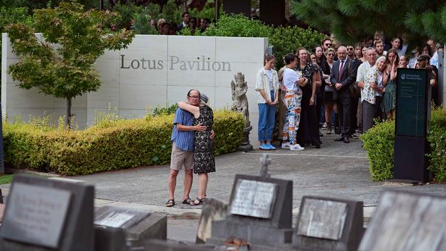 Mr Wong’s mother embraces a man after the heartfelt ceremony. Picture: NewsWire / Flavio Brancaleone