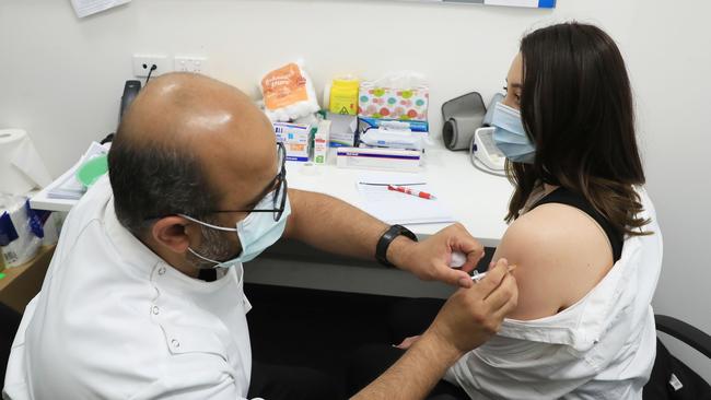 Soriah Lambrousis, 28, receives the AstraZeneca vaccine from pharmacist Nadeem Ahmad in Liverpool, south-west Sydney, on Wednesday. Picture: John Feder