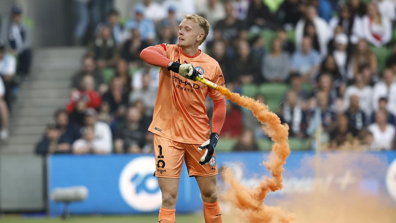 Tom Glover of Melbourne City picks up a flare at AAMI Park (Photo by Darrian Traynor/Getty Images)