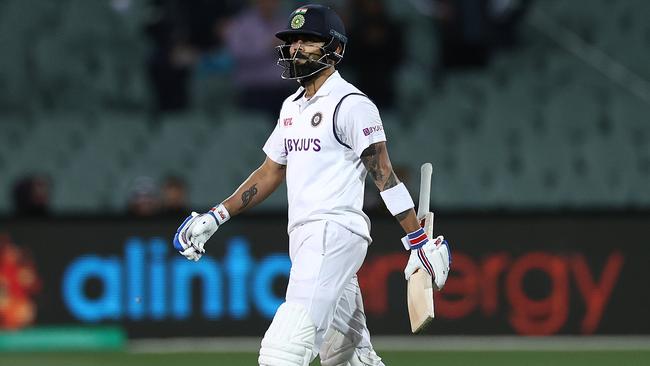 A dejected Virat Kohli walks off the field after being run-out by Josh Hazlewood.