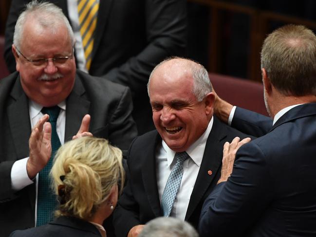 Nationals Senator John Williams is congratulated after making his valedictory speech in the Senate chamber at Parliament House in Canberra at Parliament House in Canberra, Wednesday, February 13, 2019. (AAP Image/Mick Tsikas) NO ARCHIVING