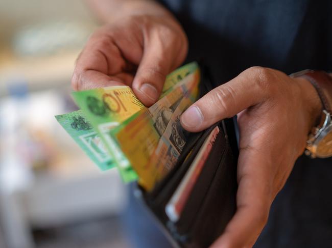 a male taking money out of the valet.