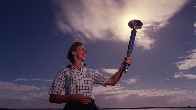 Glynis Nunn holding 1956 Melbourne Olympic Games Torch