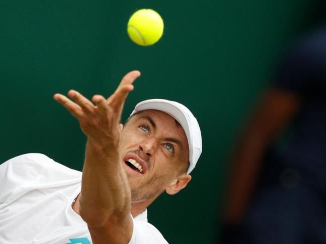 Australia's John Millman serves to US player Sam Querrey during their men's singles third round match on the sixth day of the 2019 Wimbledon Championships at The All England Lawn Tennis Club in Wimbledon, southwest London, on July 6, 2019. (Photo by Adrian DENNIS / AFP) / RESTRICTED TO EDITORIAL USE