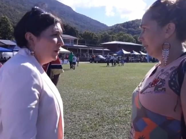 QLD Environment Minister Leeanne Enoch talks to an anti Adani portestor in Cairns.