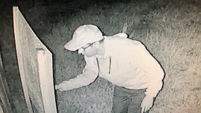 Police want to question this man, who is seen vandalising a Geoff Lee campaign poster under the cover of darkness.