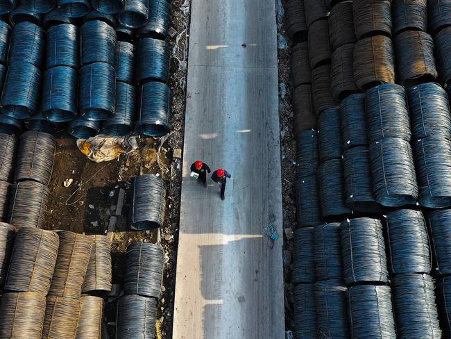 An aerial view shows people walking at a wholesale steel market in Shenyang, in northeastern China's Liaoning province on April 11, 2024. (Photo by AFP) / China OUT