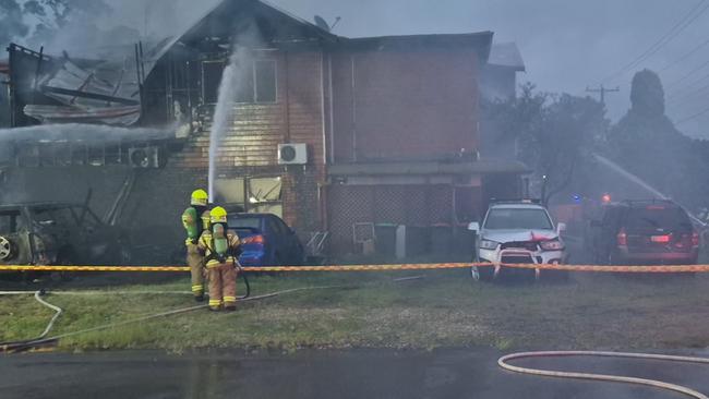 Blaze takes hold of a Bonnells Bay home, in Lake Macquarie, on January 30th after a nearby caravan caught alight. Around 30 firefighters fought to contain the blaze. Credit: NSW Fire and Rescue