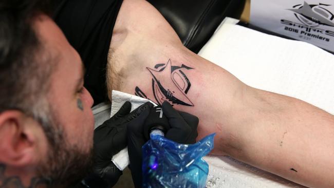 Cronulla Sharks player Paul Gallen getting a tattoo by Glen Middleton after winning the NRL premiership. Pictured at Royal Tattoo Studio, Sydney. Picture: Gregg Porteous (MUST INCLUDE ROYAL TATTOO STUDIO IN CAPTION)