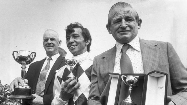 Gala Supreme owner Pat Curtain, (far left) holds the 1973 Melbourne Cup with jockey Frank Reys alongside and (front) trainer Ray Hutchins.