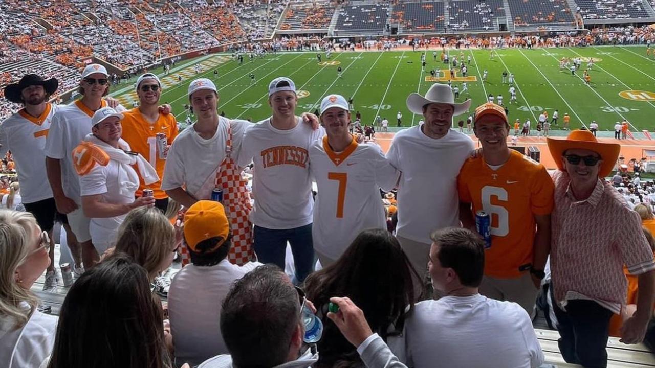 Lions players take in a college football game.
