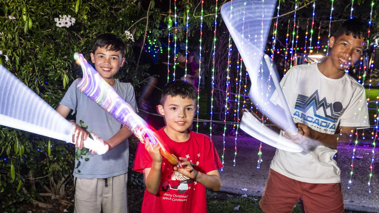 Brothers (from left) Cayden, Harry and Neoby Weber having fun with light toys at Toowoomba's Christmas Wonderland in Queens Park, Saturday, December 7, 2024. Picture: Kevin Farmer