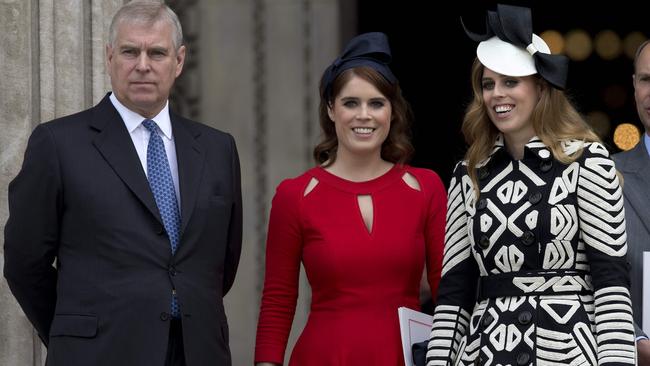 Prince Andrew, left, Princess Eugenie second left, and Princess Beatrice of York right, leave after attending a national service of thanksgiving for the 90th birthday of the Queen Elizabeth.