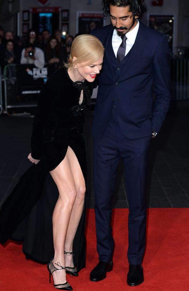 Nicole Kidman struggles with her dress as her co-star Dev Patel watches on. Picture: Anthony Harvey/Getty Images