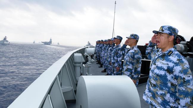 A PLA Navy fleet including the aircraft carrier Liaoning, submarines, vessels and fighter jets take part in a review in the South China Sea on April 12, 2018. Picture: Getty