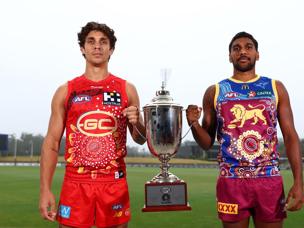 Gold Coast’s Sean Lemmens (left) and Brisbane Lions defender Keidean Coleman hope to celebrate the Sir Doug Nicholls Round by winning the QClash. Picture: Chris Hyde/Getty Images