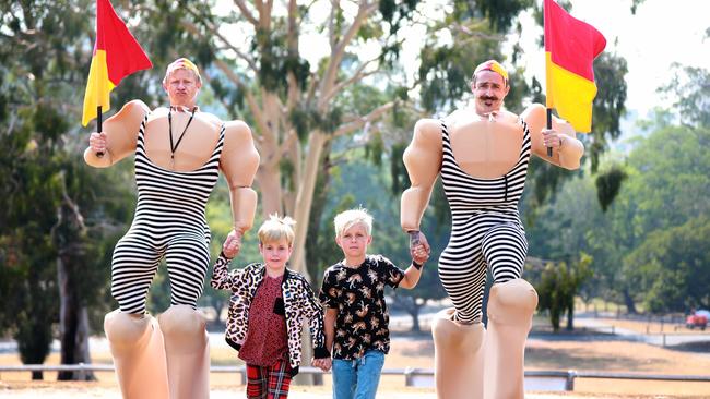 Stilt performers Terry Towelling (Jess Horne) and Sandy Crack (Paul Jones) with Sydney 8, and his brother Johnny McCautley, 10, at Parramatta Park ahead of Australia Day. Picture: Angelo Velardo