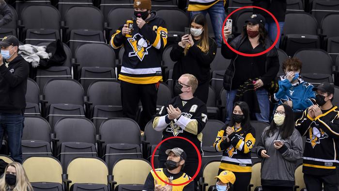 In the original image, masks aren't completely covering the faces of two fans.