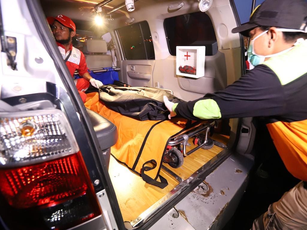 Rescue personnel transfer a bag containing human remains into an ambulance at port in Tanjung Priok, North Jakarta. Picture: AFP