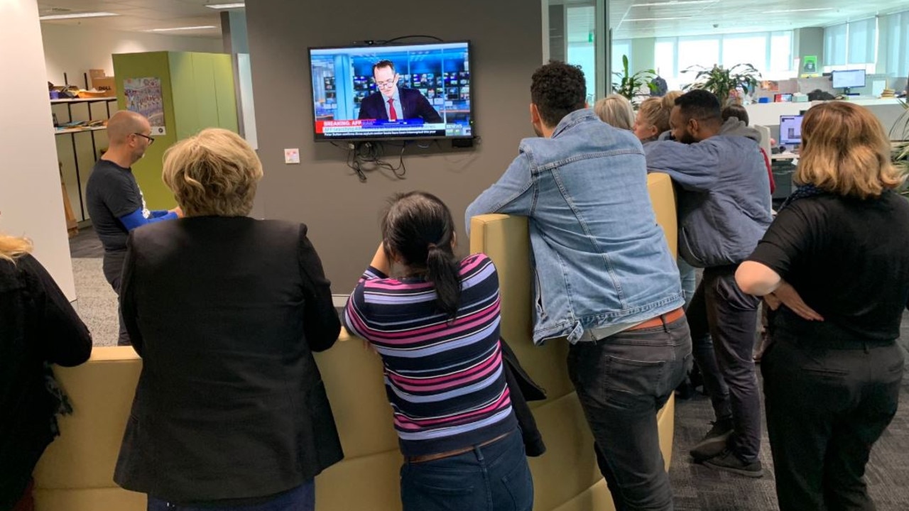 ABC staff watch live coverage of the AFP raid on their offices. Picture: Siobhan Hegarty