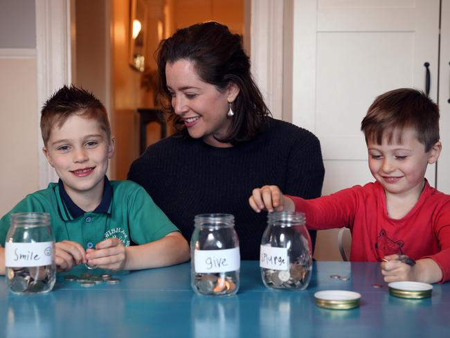 Georgie Gonczi with kids Monty, 7, and Louis, 4, pictured with their "Barefoot Investor" jars. Picture: Sam Ruttyn