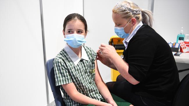 12-year-old Caitlyn Connors receives the Pfizer Covid-19 vaccine at the newly opened Covcommunity vaccination hub at the Brisbane Entertainment Centre in Boondall. Picture: NCA NewsWire/Dan Peled.