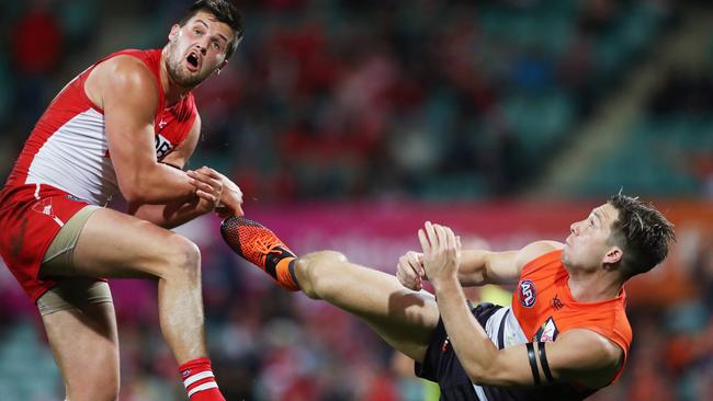 Toby Greene kicks Sydney’s Nic Newman while trying to take a mark. Picture: Phil Hillyard