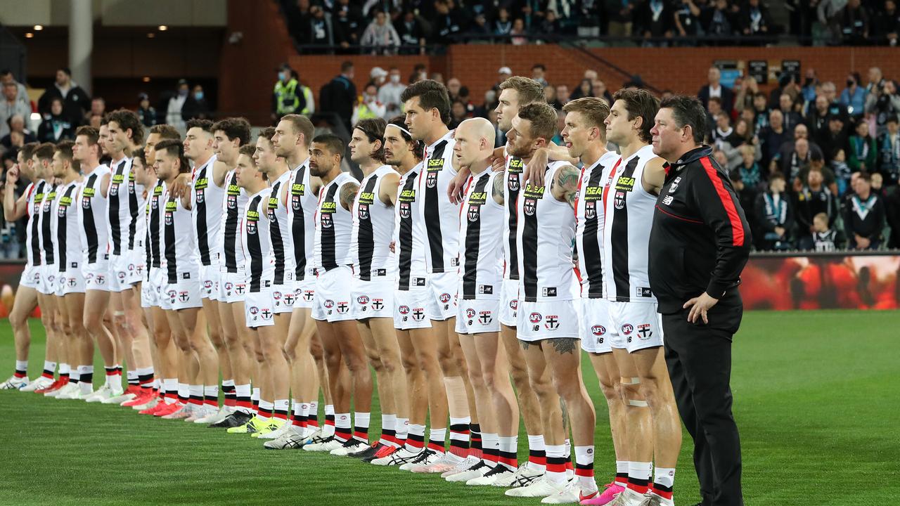 ADELAIDE, AUSTRALIA - APRIL 25: St Kilda and Port players stand for Anzac Day service during the 2021 AFL Round 06 match between the Port Adelaide Power and the St Kilda Saints at Adelaide Oval on April 25, 2021 in Adelaide, Australia. (Photo by Sarah Reed/AFL Photos via Getty Images)