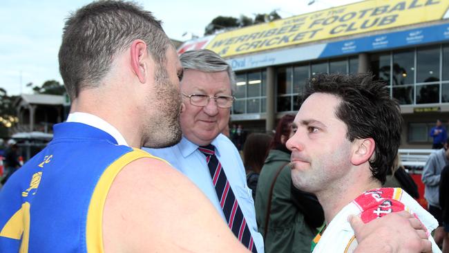 Spotswood’s Chris O'Keefe is commiserated by Deer Park’s Craig Morrison after the game.