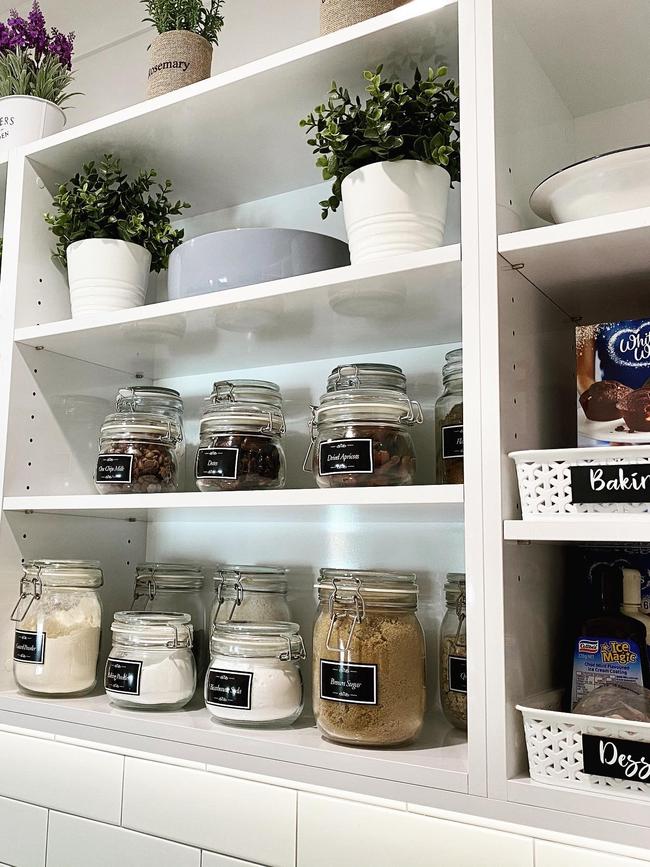 It also features matching white tea cups and plastic crates with faux pot plants in between some jars. Picture: Facebook