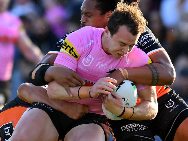 BRISBANE, AUSTRALIA - AUGUST 29:  Dylan Edwards of the Panthers is tackled during the round 24 NRL match between the Penrith Panthers and the Wests Tigers at Moreton Daily Stadium on August 29, 2021, in Brisbane, Australia. (Photo by Albert Perez/Getty Images)