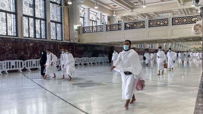 Saudis and foreign residents walk down a hallway during Umrah in the Grand Mosque complex in the holy city of Mecca on Sunday. Picture: AFP