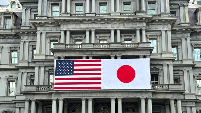 US and Japanese flags are seen posted on the Eisenhower Executive Office Building next to the White House in Washington, DC, on April 5, 2024 in preparation for next week's official state visit of Japanese Prime Minister Fumio Kishida. Picture: AFP.