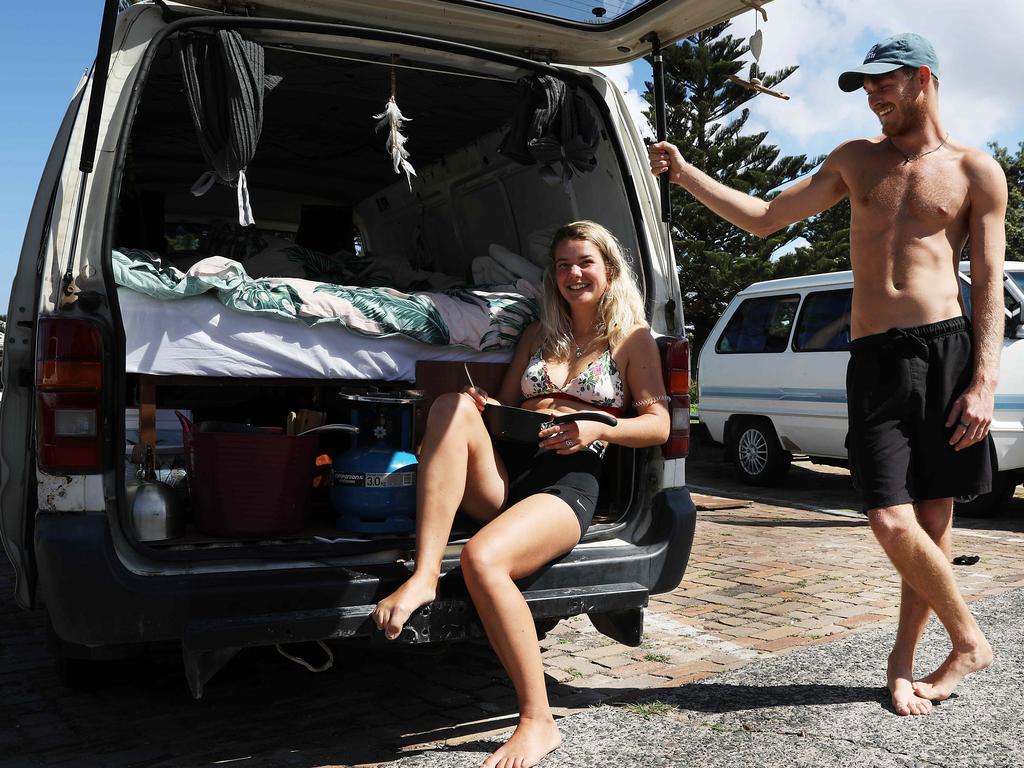 Backpacker neighbours Justine Van den Mooter (23) from Belgium and Tom Eden (24) from England cook lunch in Justine's van at Bondi Beach. Picture: Jane Dempster/The Australian.