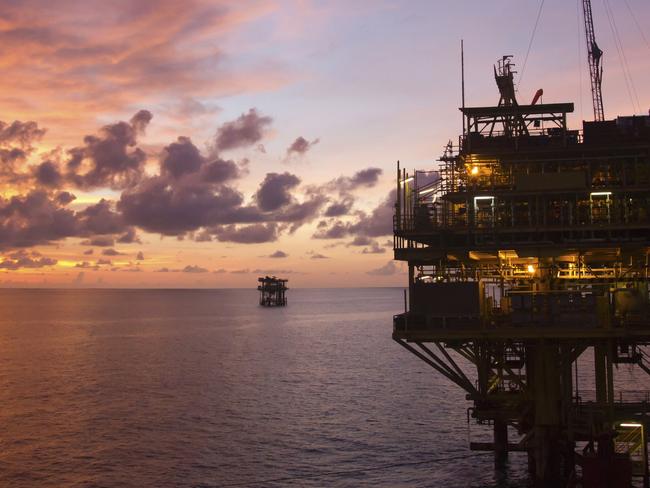 Silhouette of an offshore oil rig at sunset