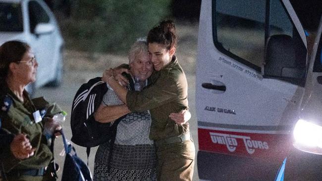 An Israeli soldier embraces former captive Margalit Moses upon her arrival in Israel. Picture: Israel Army/ AFP