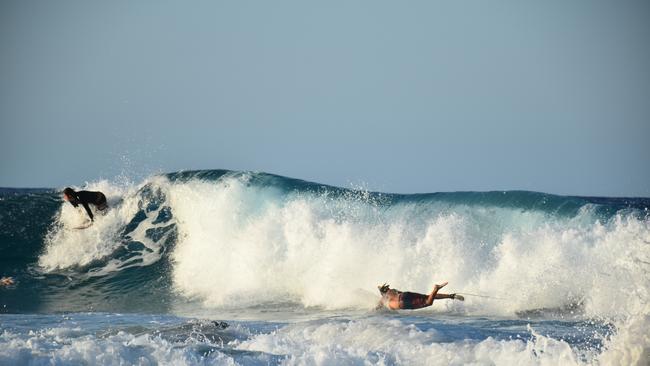 Young swimmers knocked down by swell at Snapper Rocks on the Gold Coast generated by Tropical Cyclone Oma. Picture: Mark Furler