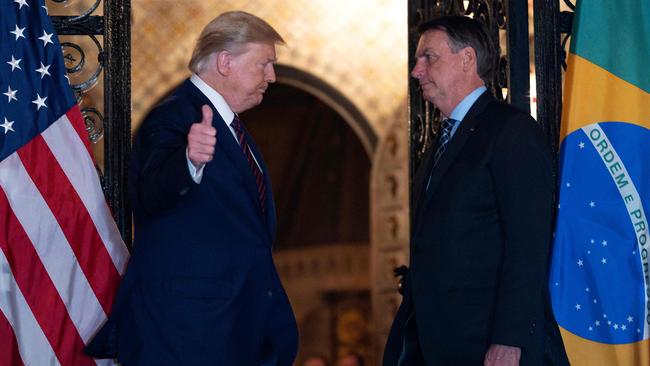 US President Donald Trump (left) speaks with Brazilian President Jair Bolsonaro during a dinner at Mar-a-Lago at Palm Beach, Florida. Picture: AFP