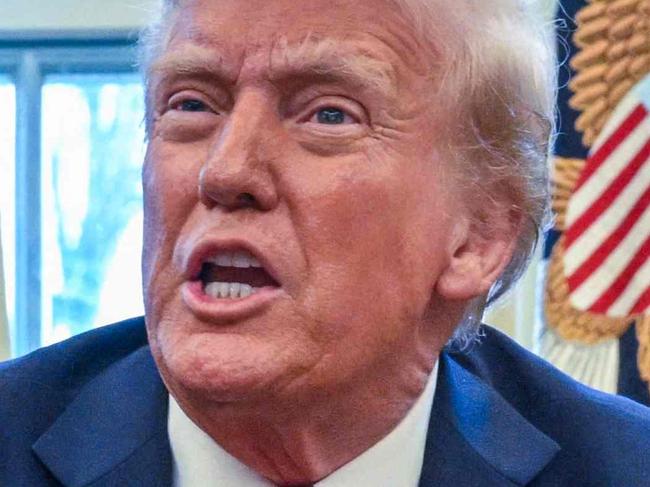 TOPSHOT - US President Donald Trump speaks to the press before signing an executive order in the Oval Office of the White House in Washington, DC, on January 30, 2025. (Photo by ROBERTO SCHMIDT / AFP)