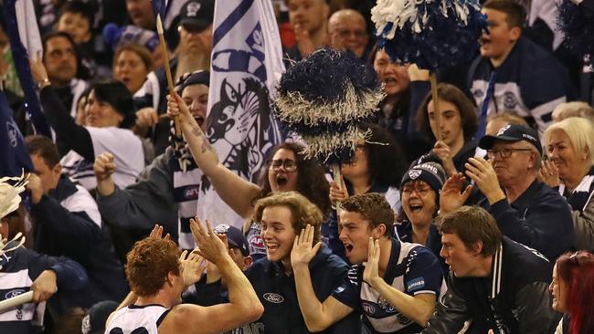 Gary Rohan embraces the Marvel Stadium crowd after booting a goal for Geelong.