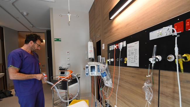 Dr Michael Ben-Meir, Director of Emergency Medicine at Cabrini, inspects a portable oxygen respirator in a coronavirus isolation room. Picture: AAP