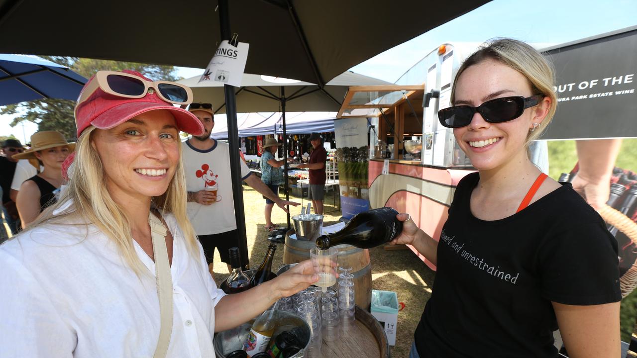 Carissa Armstrong, left, samples a wine at the Flying Brick stall poured by Sophie Manson. Picture: Mike Dugdale