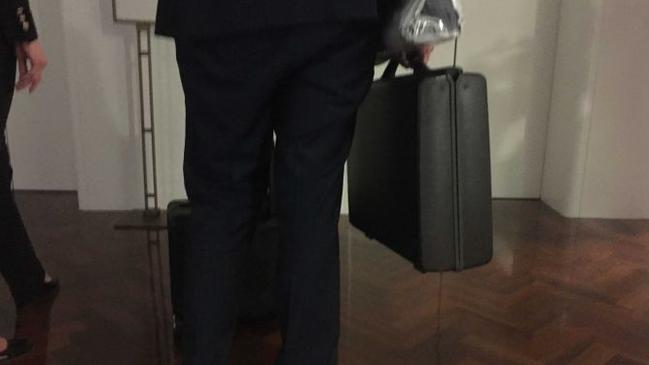 An ASIO officer retrieves the Cabinet documents last night. Picture: ABC News